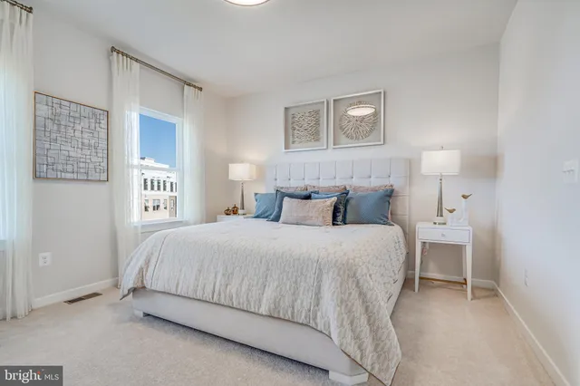 a bedroom with a large bed and a chandelier