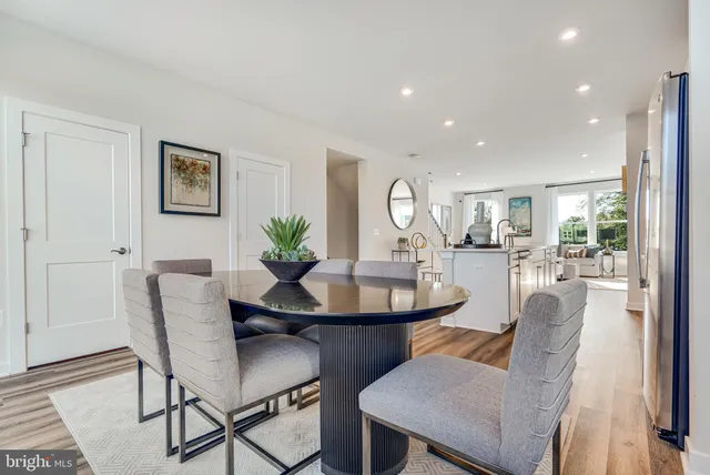 a kitchen with stainless steel appliances granite countertop a stove a sink dishwasher and a microwave with wooden floor