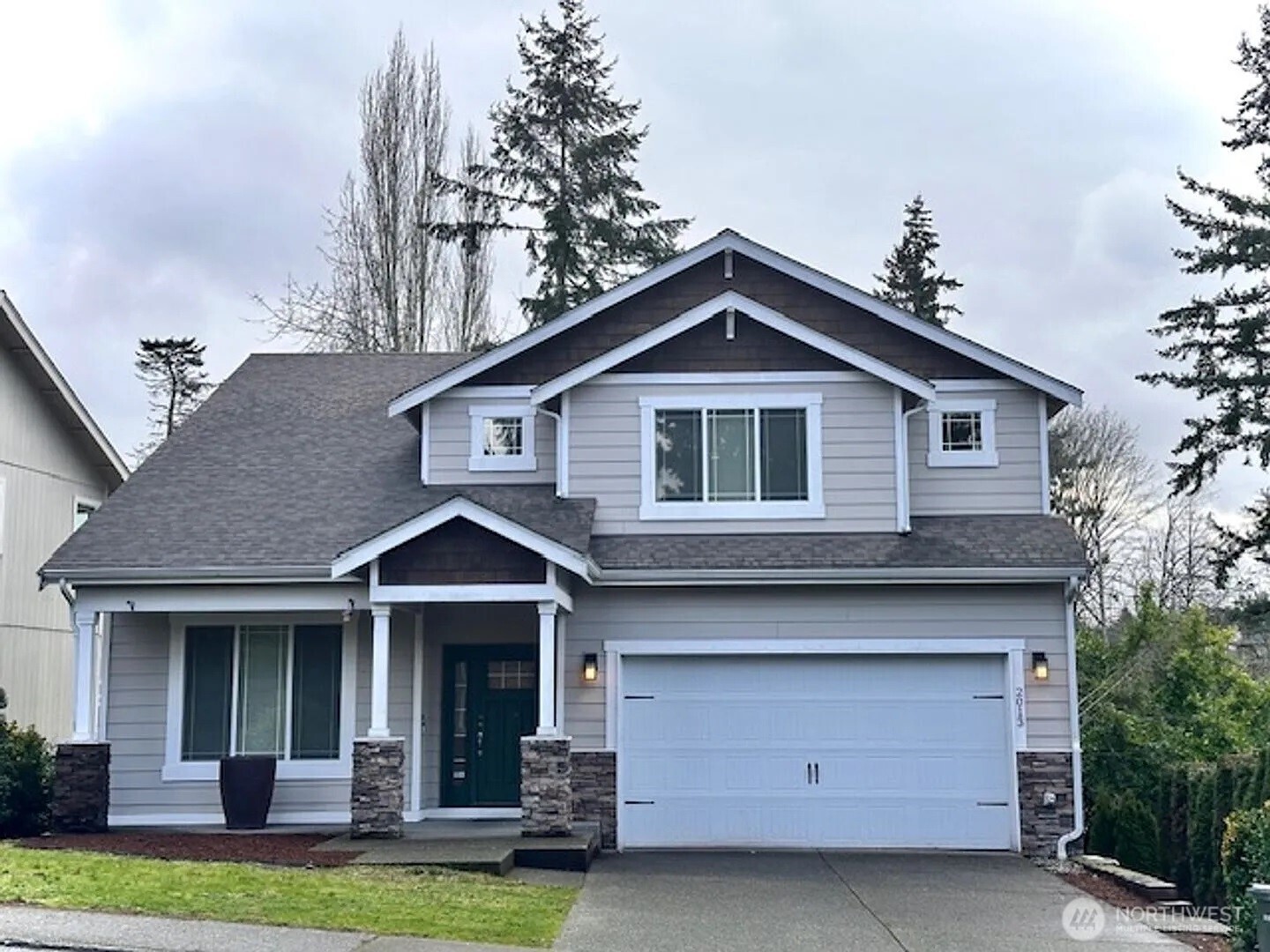 2013 Northeast 27th Street Renton, WA 98056 - Photo 1 of 25 a front view of a house with a yard garage and outdoor seating