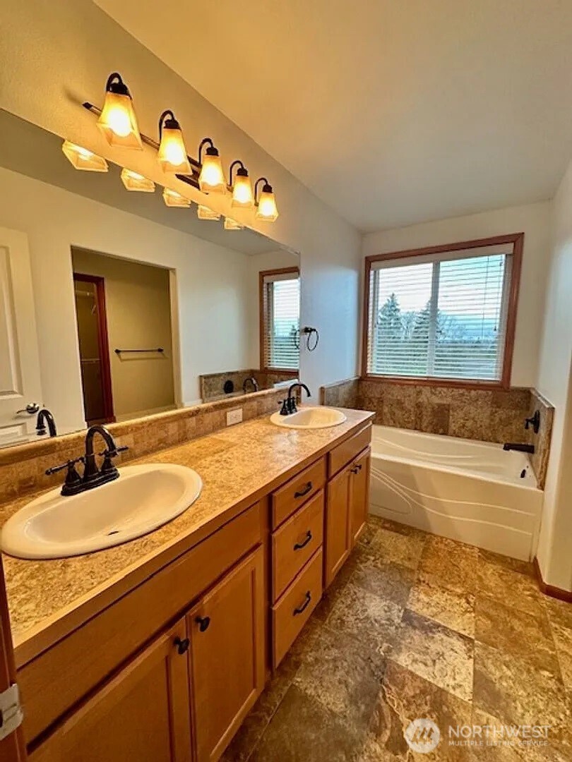 2013 Northeast 27th Street Renton, WA 98056 - Photo 18 of 25 a bathroom with a tub sink and mirror