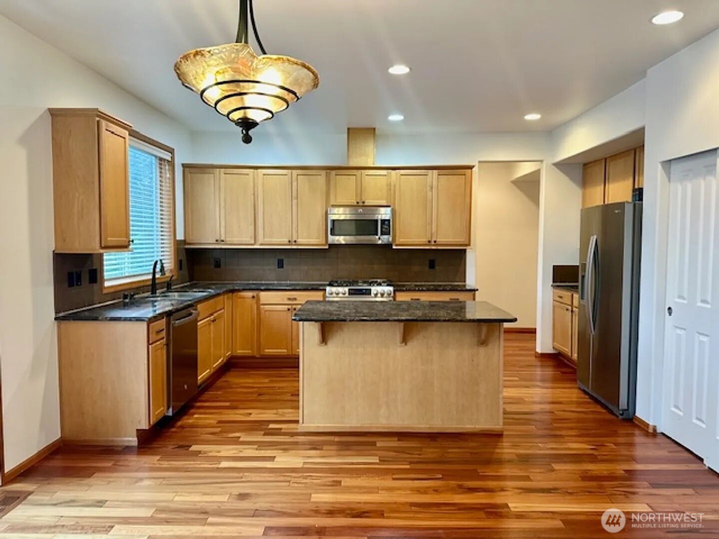 2013 Northeast 27th Street Renton, WA 98056 - Photo 3 of 25 a kitchen with stainless steel appliances granite countertop a stove a sink and a refrigerator