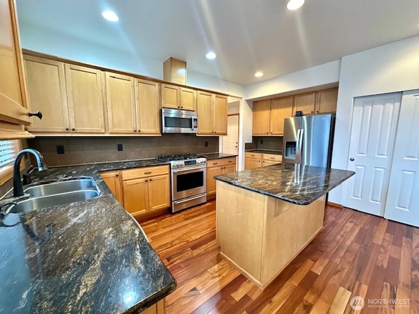 2013 Northeast 27th Street Renton, WA 98056 - Photo 4 of 25 a kitchen with stainless steel appliances granite countertop a sink stove and refrigerator