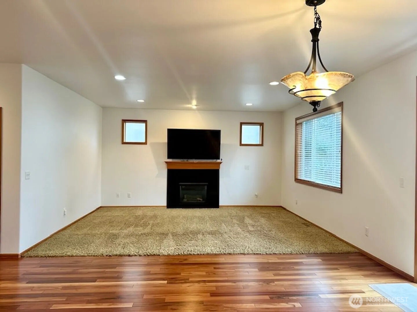 2013 Northeast 27th Street Renton, WA 98056 - Photo 7 of 25 a view of a livingroom with a chandelier fan and wooden floor