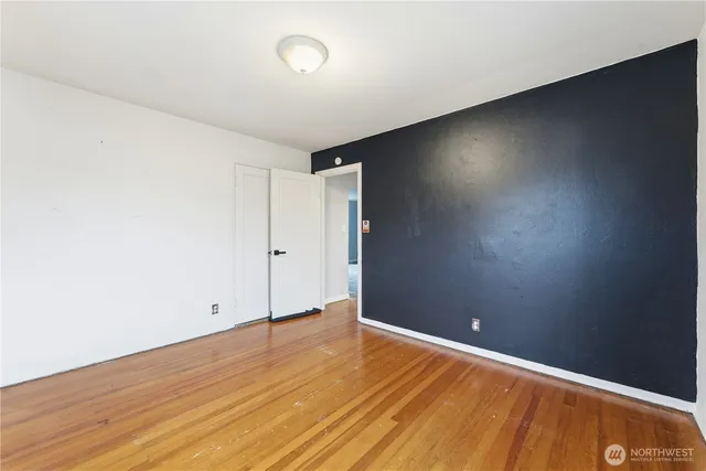 an empty room with wooden floor