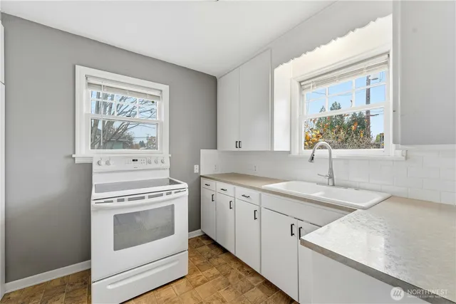 a kitchen with a stove oven and sink