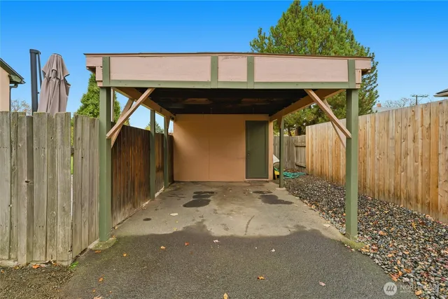 a view of a house with a wooden fence