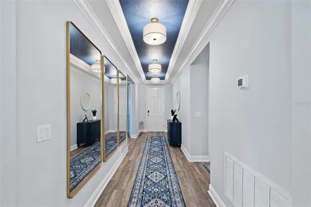 a kitchen with a dining table chairs and white cabinets