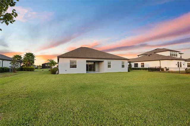 an aerial view of residential houses with outdoor space and river