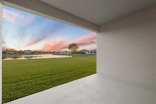 an aerial view of residential houses with outdoor space and ocean view