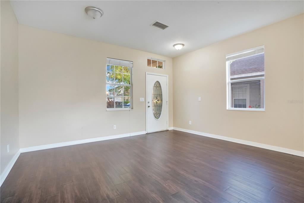 15031 Skip Jack Loop Lakewood Ranch, FL 34202 - Photo 4 of 27 an empty room with wooden floor and windows