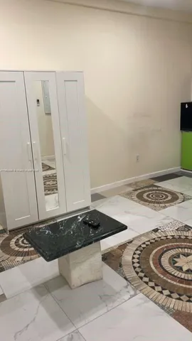 a living room with furniture and a rug