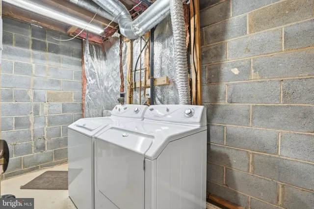 a bathroom with a sink shower and a mirror
