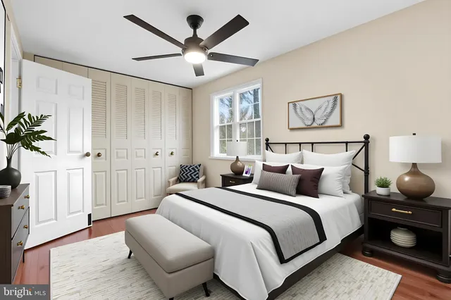 a bedroom with bed and a chandelier