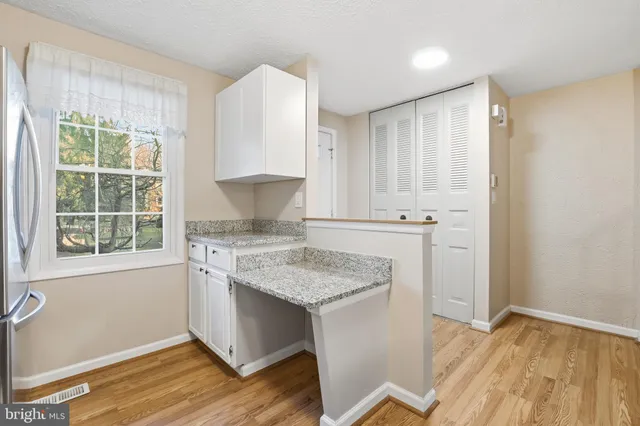 a kitchen with a stove and white cabinets