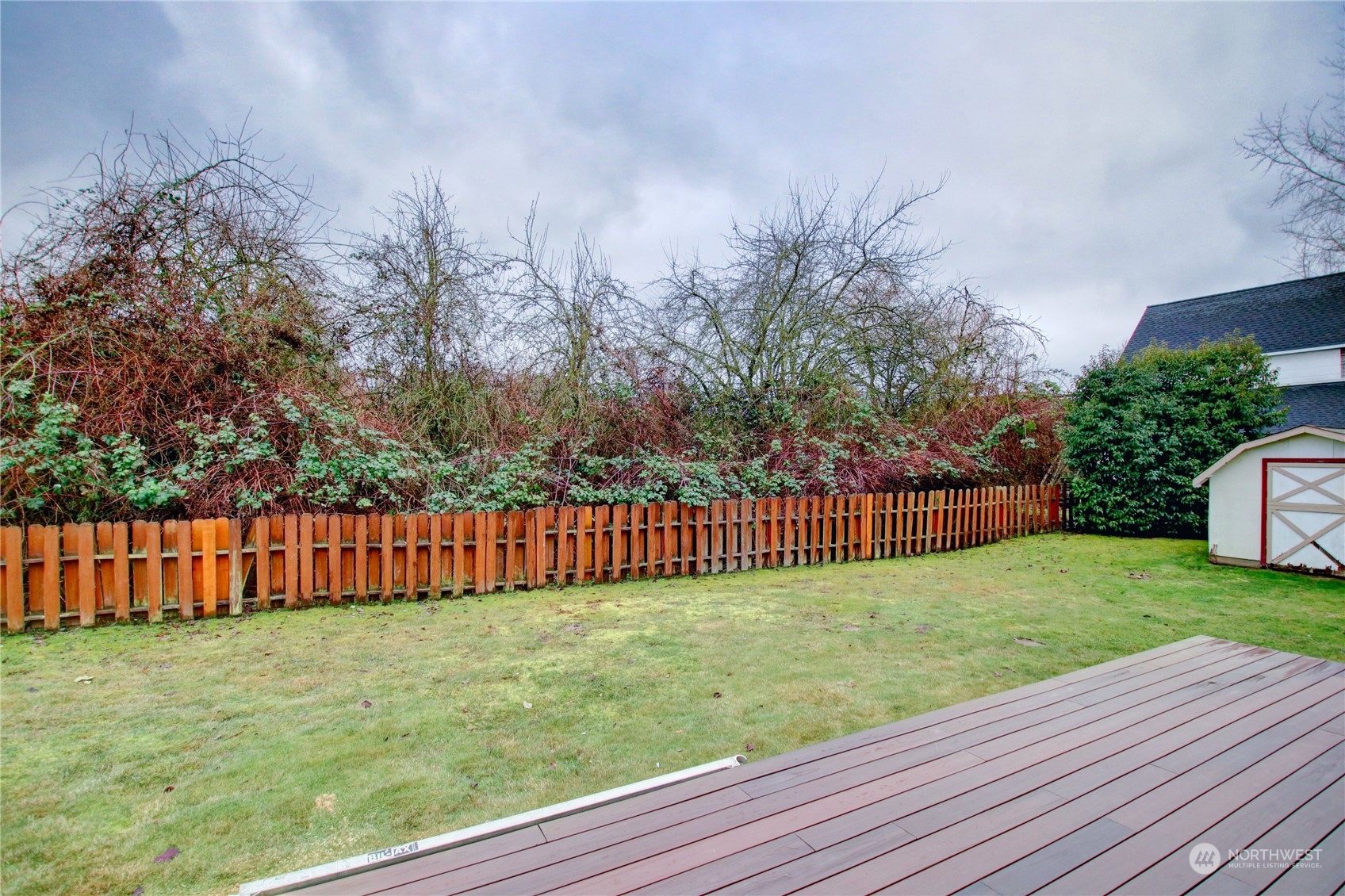 16614 Dunbar Road Mount Vernon, WA 98273 - Photo 31 of 40 a view of a yard with large trees and wooden fence