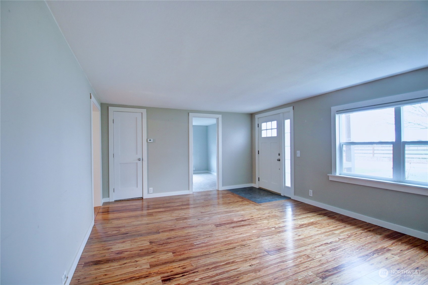 16614 Dunbar Road Mount Vernon, WA 98273 - Photo 8 of 40 a view of an empty room with wooden floor and a window