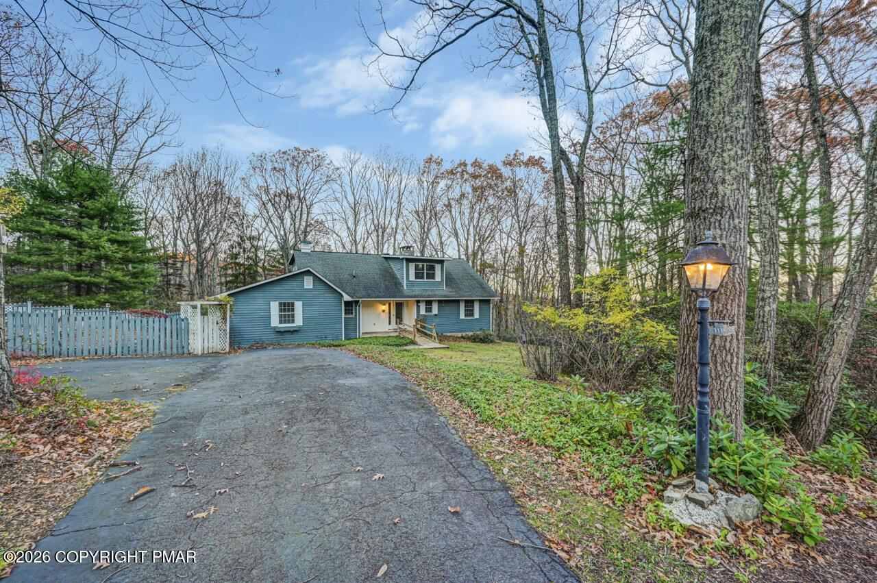 a front view of a house with a yard and trees