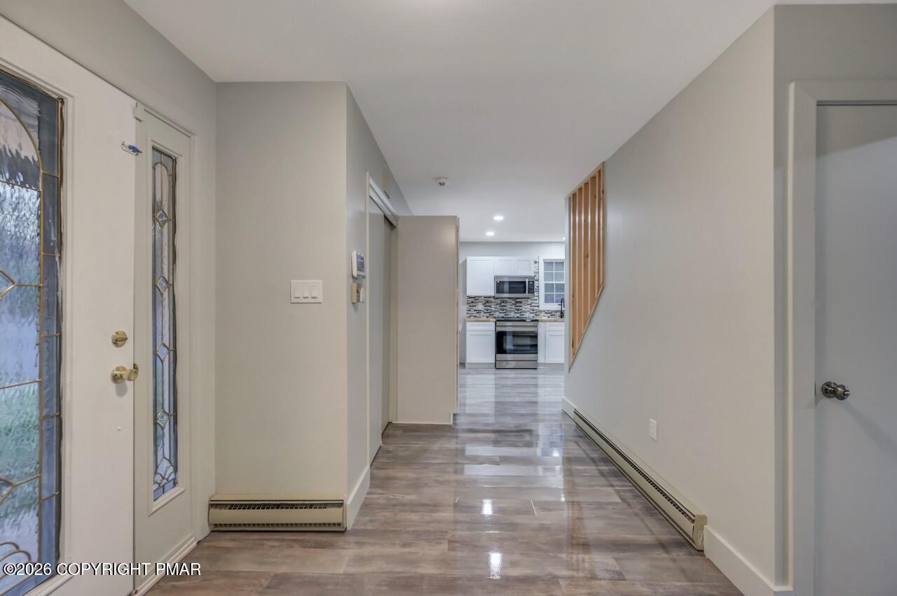 384 Devils Hole Road Cresco, PA 18326 - Photo 14 of 55 a view of a hallway with wooden floor and staircase