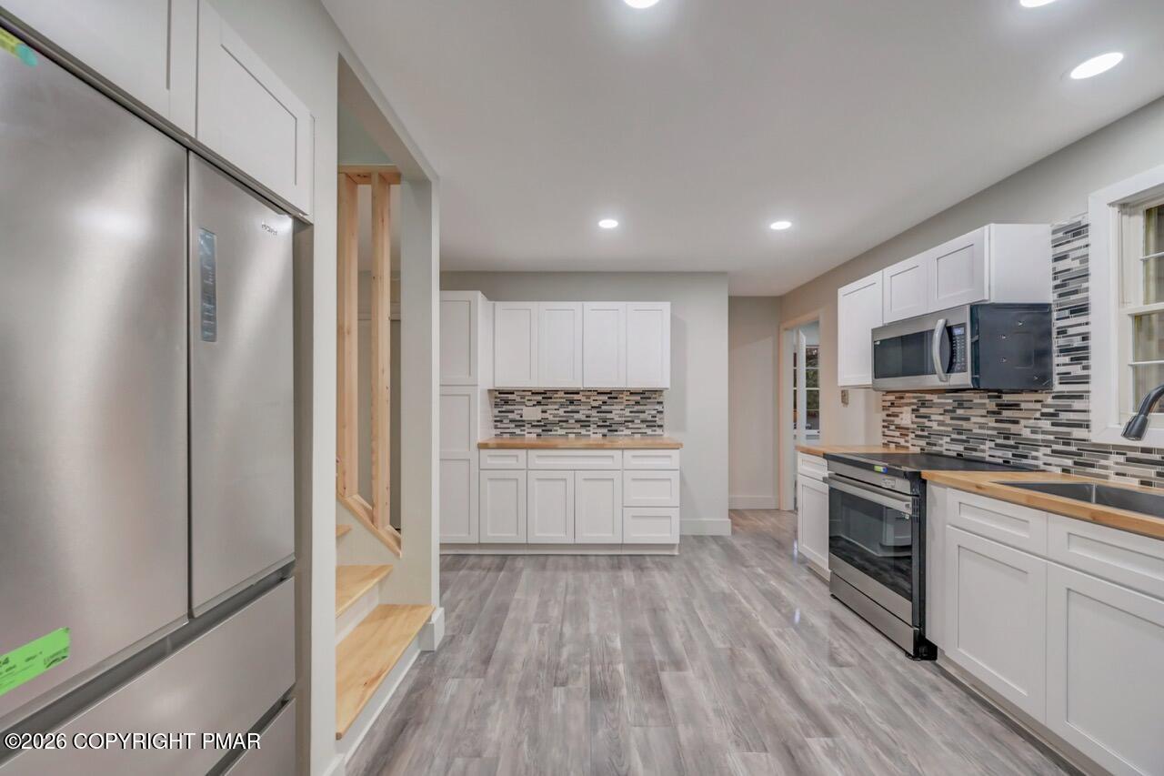 384 Devils Hole Road Cresco, PA 18326 - Photo 15 of 55 a large kitchen with a stove top oven and refrigerator