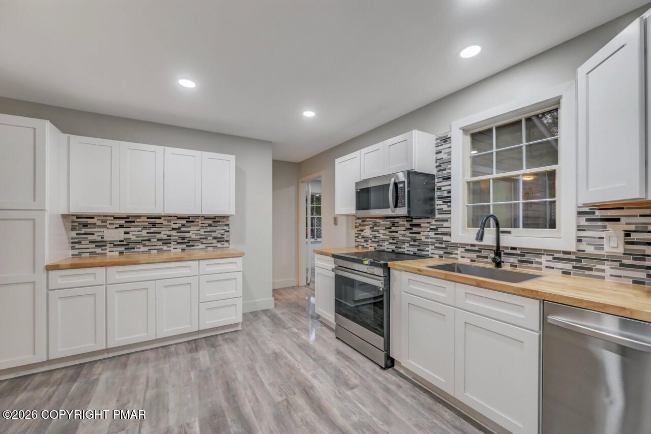 384 Devils Hole Road Cresco, PA 18326 - Photo 16 of 55 a kitchen with a sink stove and refrigerator