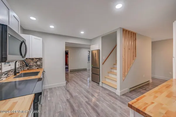 a kitchen with stainless steel appliances kitchen island granite countertop a stove and a sink