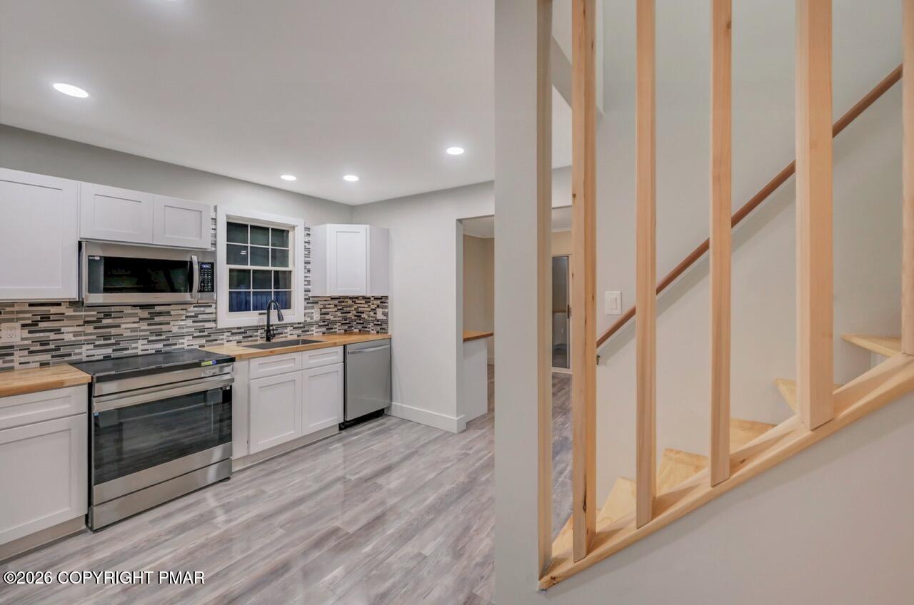 384 Devils Hole Road Cresco, PA 18326 - Photo 20 of 55 a kitchen with stainless steel appliances kitchen island granite countertop a stove and a sink