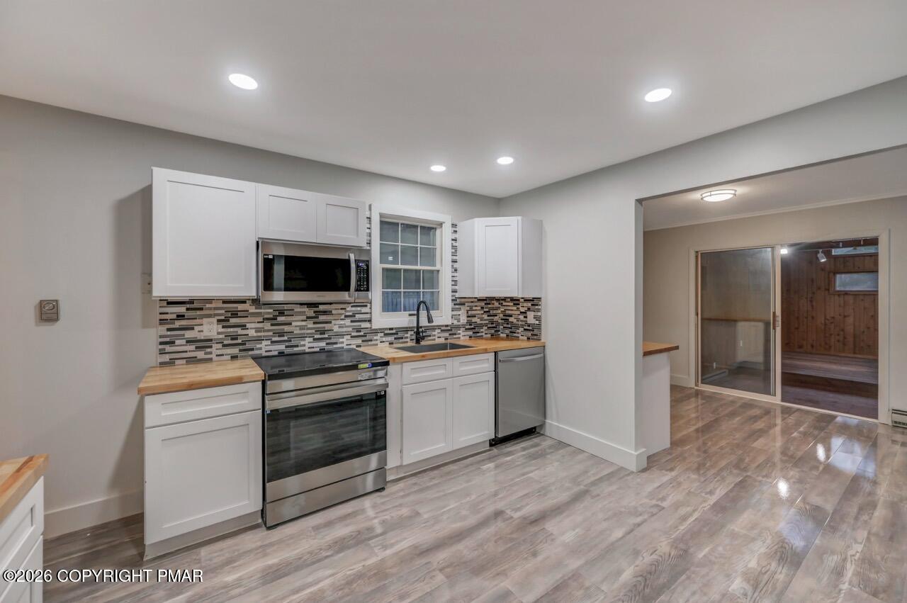 384 Devils Hole Road Cresco, PA 18326 - Photo 21 of 55 a kitchen with stainless steel appliances kitchen island granite countertop a stove and a sink