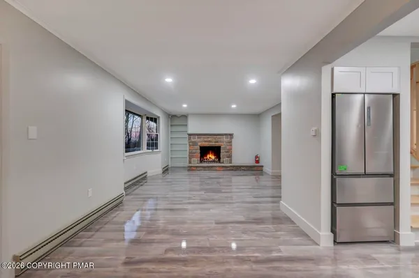 a view of empty room with wooden floor