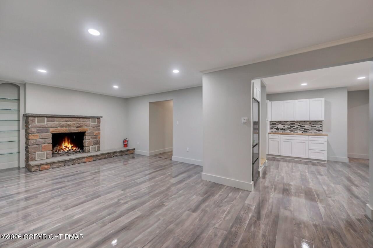 384 Devils Hole Road Cresco, PA 18326 - Photo 25 of 55 a view of empty room with wooden floor and fireplace
