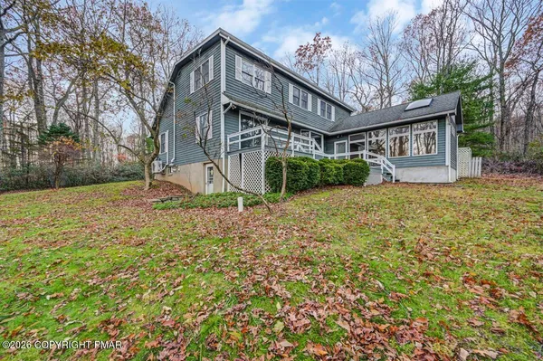 a house that has a tree in front of it