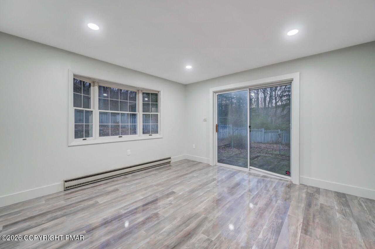 384 Devils Hole Road Cresco, PA 18326 - Photo 39 of 55 an empty room with wooden floor and windows
