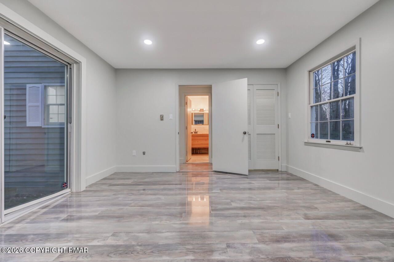 384 Devils Hole Road Cresco, PA 18326 - Photo 41 of 55 a view of an empty room with wooden floor and windows