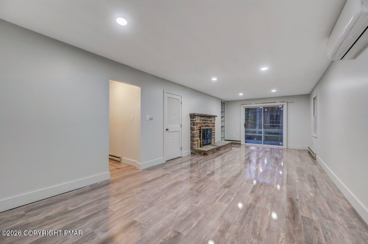 384 Devils Hole Road Cresco, PA 18326 - Photo 45 of 55 an empty room with wooden floor and window