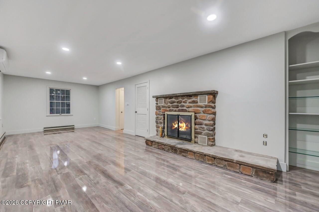 384 Devils Hole Road Cresco, PA 18326 - Photo 46 of 55 an empty room with windows and fireplace