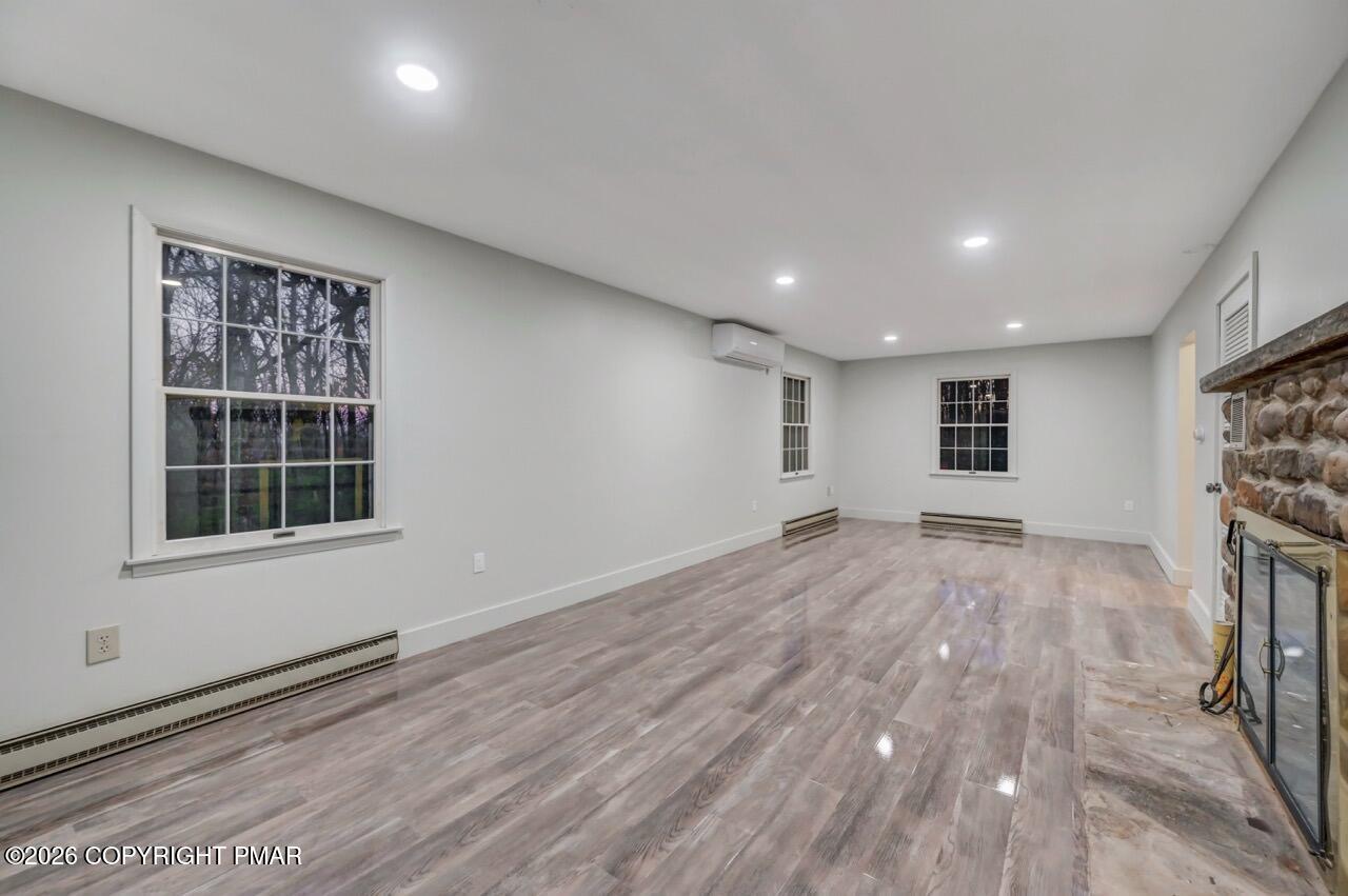 384 Devils Hole Road Cresco, PA 18326 - Photo 47 of 55 a view of empty room with wooden floor and windows