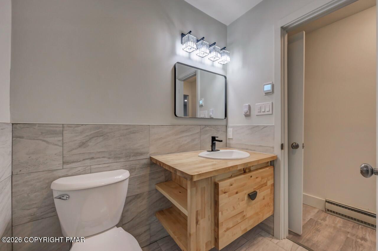 384 Devils Hole Road Cresco, PA 18326 - Photo 50 of 55 a bathroom with a toilet sink and mirror