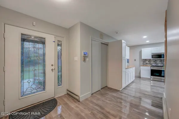 a view of a kitchen with refrigerator and microwave