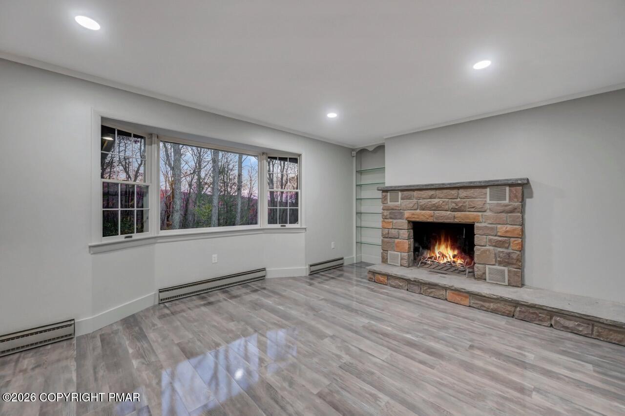 384 Devils Hole Road Cresco, PA 18326 - Photo 9 of 55 a view of an empty room with a window and fireplace