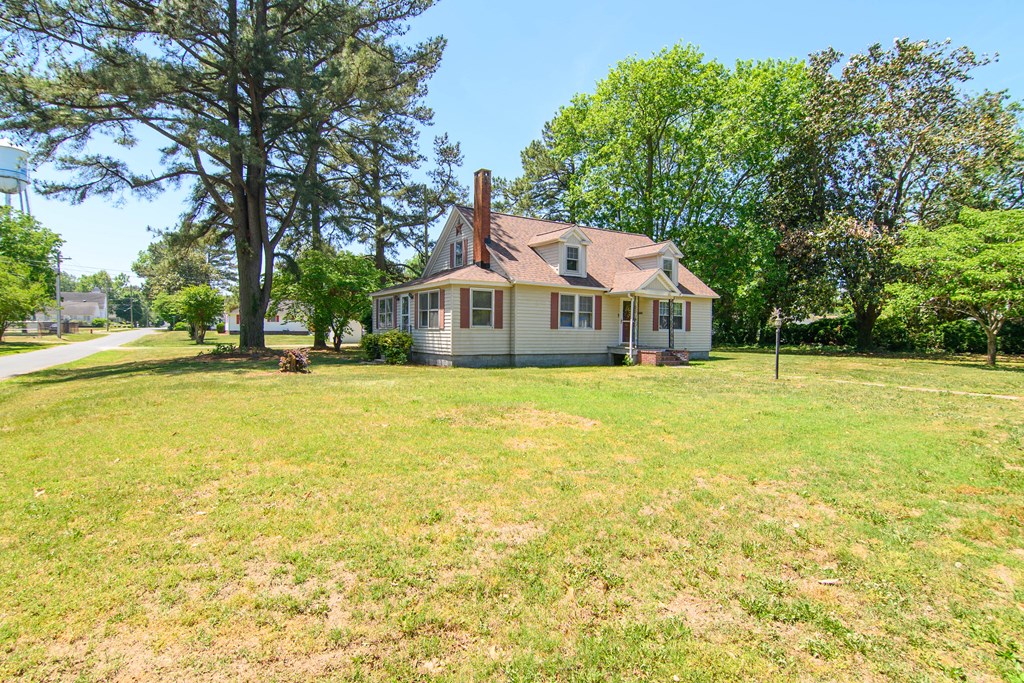 24432 Maxwell Street Parksley, VA 23421 - Photo 37 of 39 a front view of house with yard and trees around