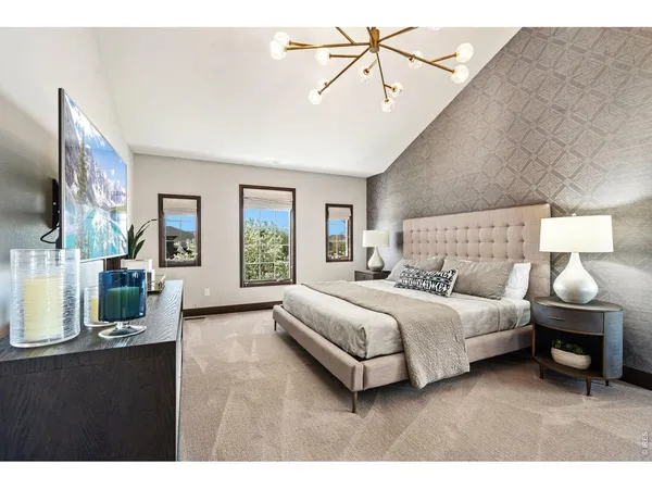 a bedroom with a bed a mirror and lamp