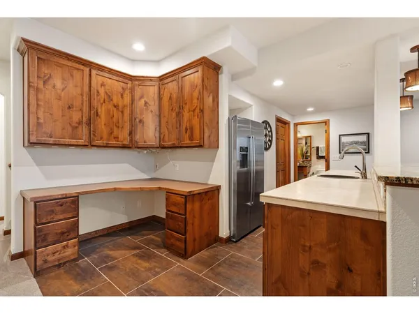 a kitchen with stainless steel appliances granite countertop a refrigerator a sink and a stove