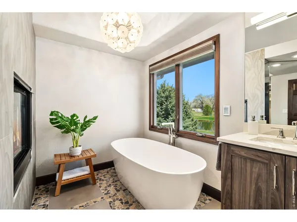 a living room with furniture a chandelier and a bathtub