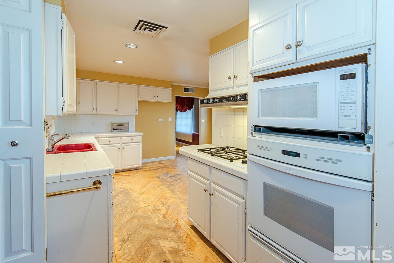1925 Greenfield Drive Reno, NV 89509 - Photo 8 of 22 a kitchen with a stove top oven sink and cabinets