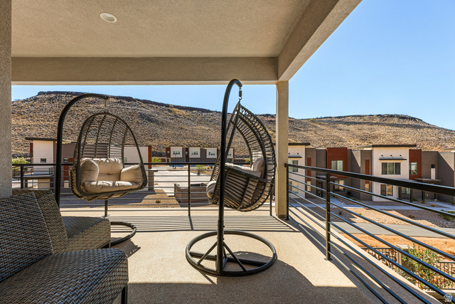 839 Walker Way St. George, UT 84770 - Photo 3 of 32 Covered balcony with textured flooring and a horizontal metal railing