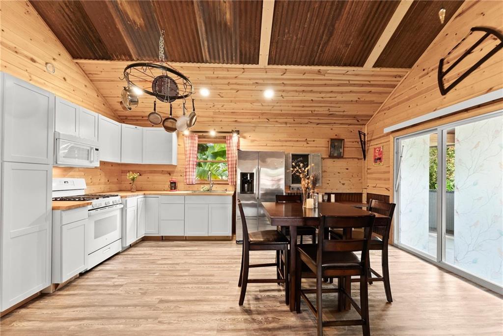 59 Rocket Drive Cleveland, GA 30528 - Photo 10 of 25 a kitchen with a table chairs and white cabinets