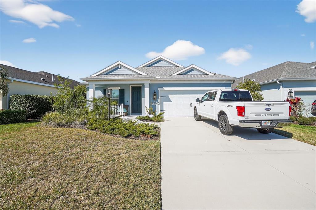 a white house covered with tall trees