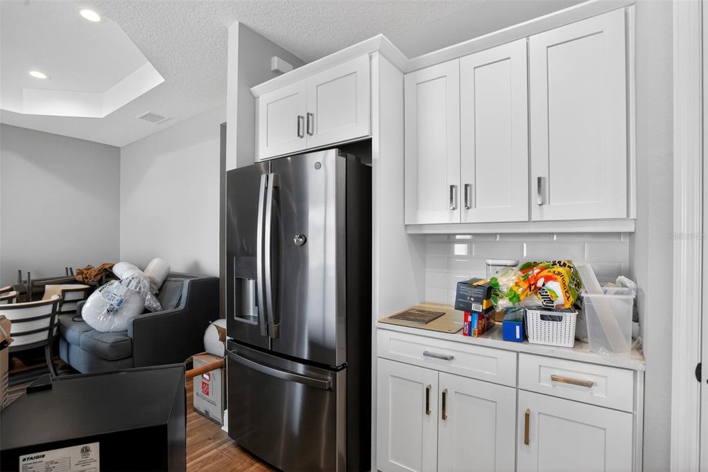 10710 Falling Leaf Court Parrish, FL 34219 - Photo 19 of 50 a kitchen with stainless steel appliances a refrigerator and cabinets