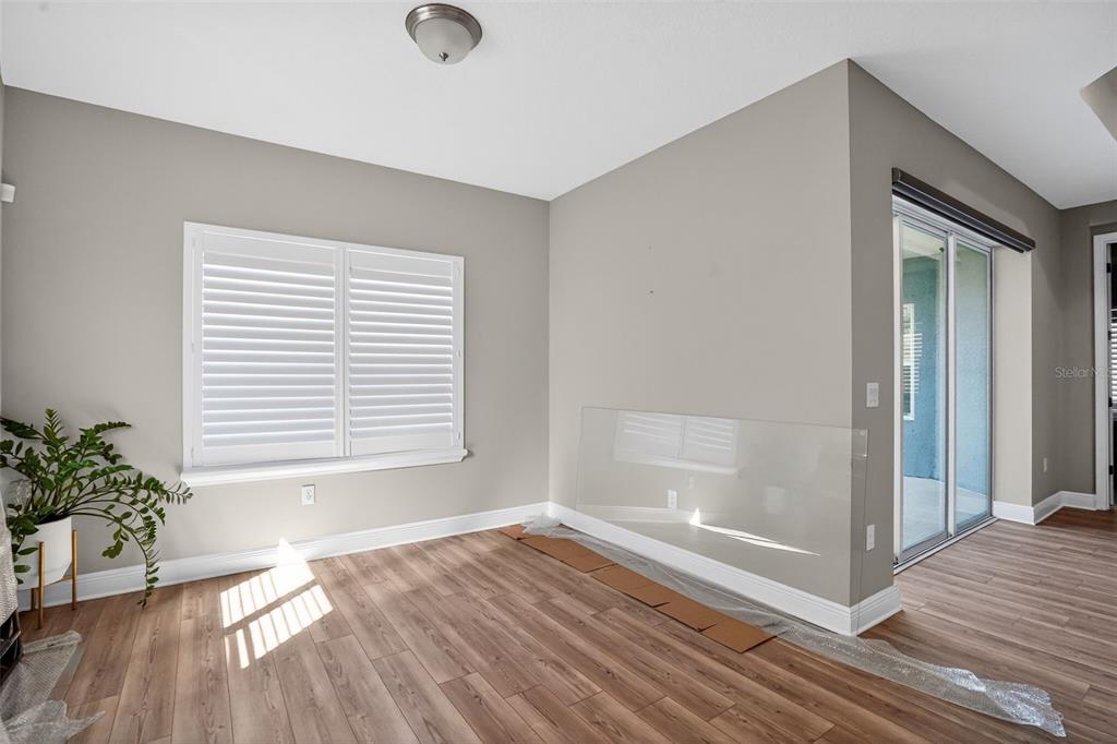 10710 Falling Leaf Court Parrish, FL 34219 - Photo 20 of 50 a view of an empty room with a window and wooden floor