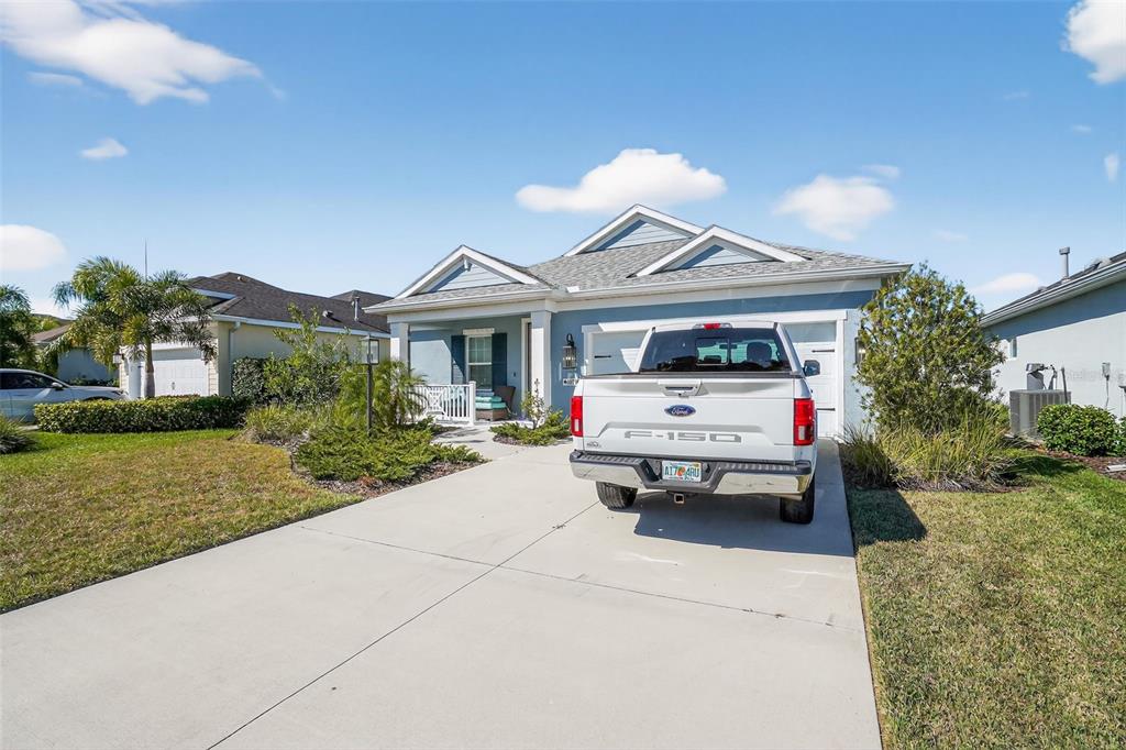 10710 Falling Leaf Court Parrish, FL 34219 - Photo 2 of 50 a white house covered with tall trees