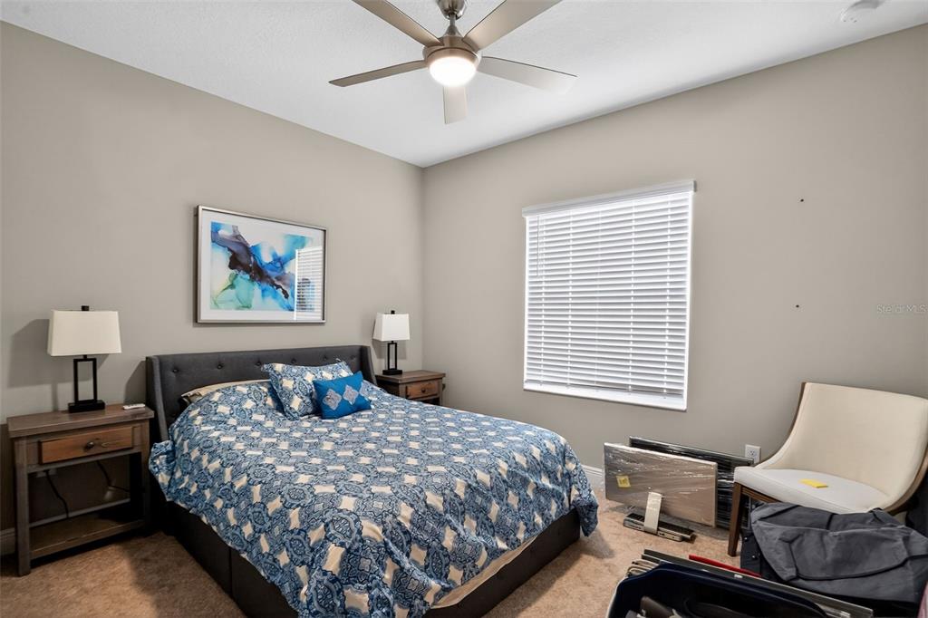 10710 Falling Leaf Court Parrish, FL 34219 - Photo 24 of 50 a bedroom with a bed and a window